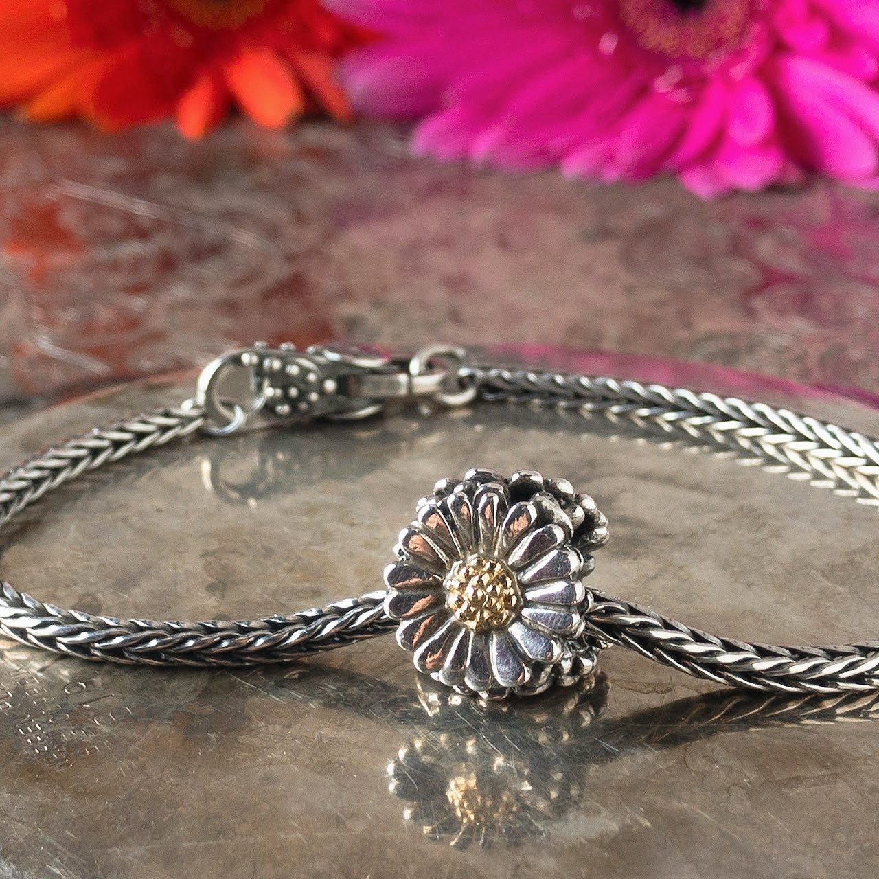 Trollbeads sterling silver and 18 karat gold "Daisy" bead on a sterling silver Trollbeads bracelet with clasp