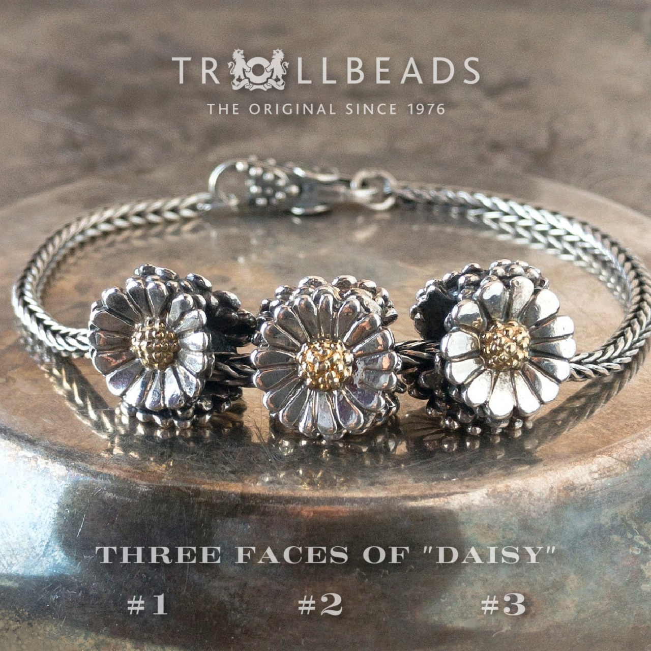 3 Trollbeads sterling silver and 18 karat gold "Daisy" beads on a sterling silver bracelet with clasp