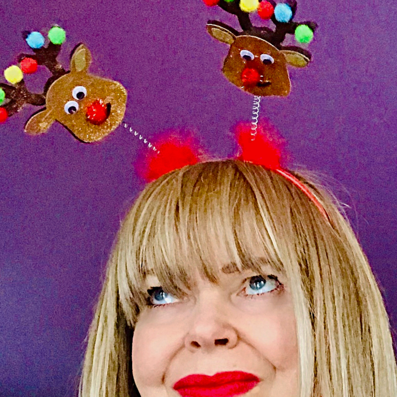 Suzie Q wearing a festive and fun Christmas reindeer hairband.