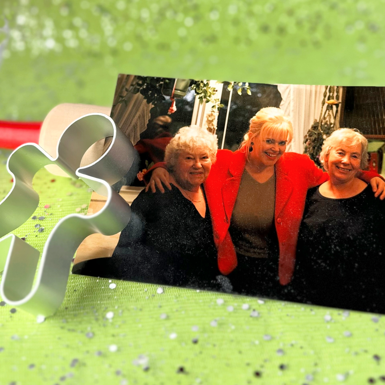 A photo of Suzie, her Mom and her Aunt in her family kitchen, beside a rolling pin and gingerbread man cookie cutter.