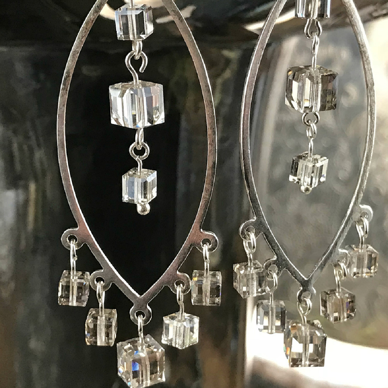 A pair of handcrafted, chandelier-style, sterling silver earrings, with Swarovski crystal cube beads, on sale at Suzie Q Studio