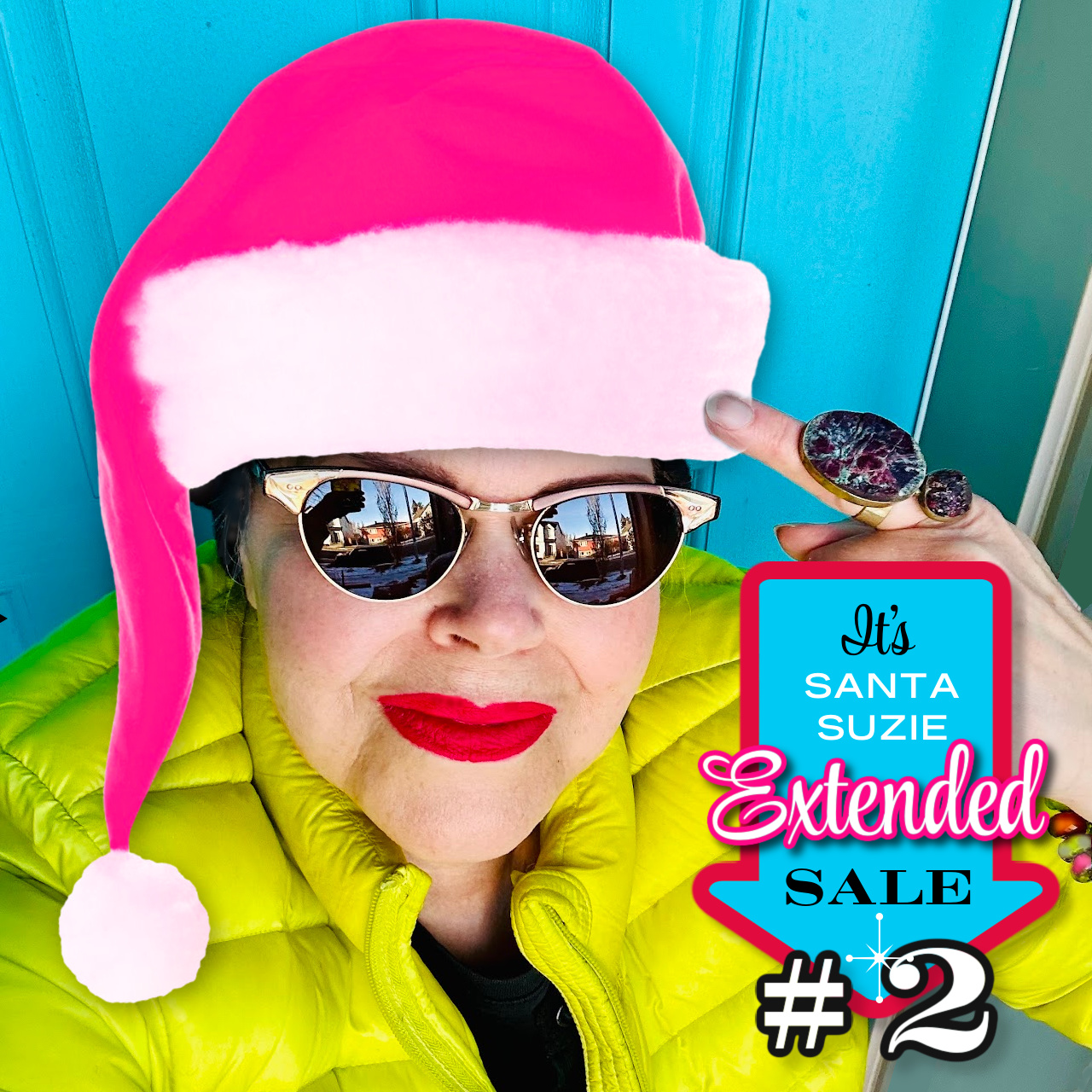 Woman wearing a hot pink Santa hat, promoting a sale at Suzie Q Studio