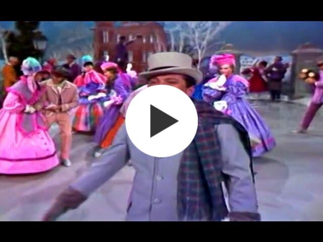 A vintage photo of an outdoor ice skating scene, featuring singer Andy Williams, along with background skaters, all wearing vintage clothing. 