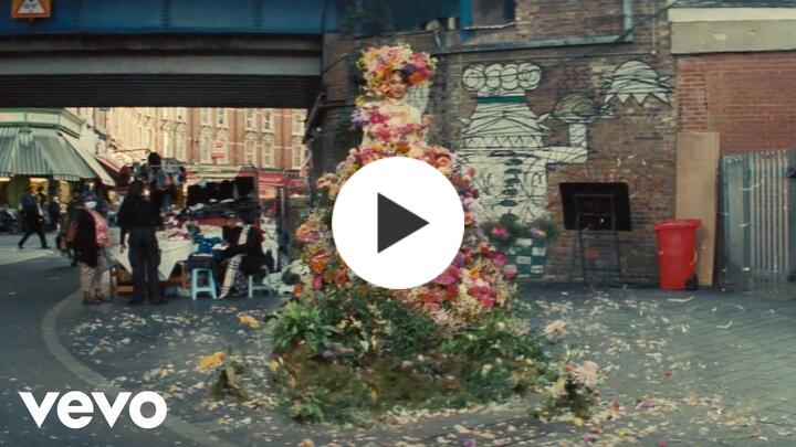Musician Joy Crooks wearing real flowers as a hat and dress for her music video "When You Were Mine"